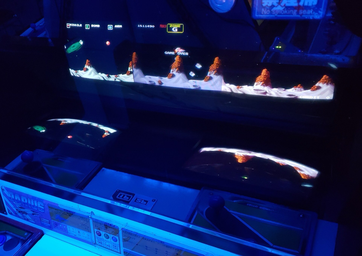 Taito Darius arcade cabinet with three CRT screens blended into one wide display